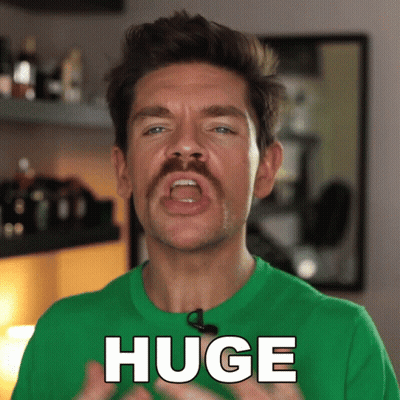 A Man With A Green Shirt Says Huge GIF