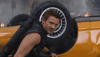A Man With A Gun On His Back Is Standing Next To A Car GIF