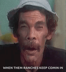 A Man With A Hat On His Head Is Making A Funny Face . GIF