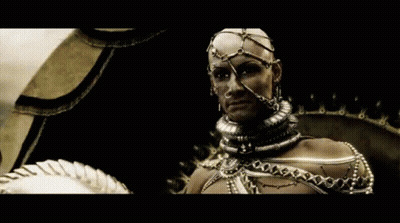 A Man With A Helmet On His Head Is Wearing A Lot Of Jewelry GIF