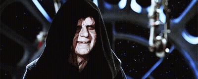 A Man With A Hood On His Head Is Smiling In Front Of A Starry Sky GIF