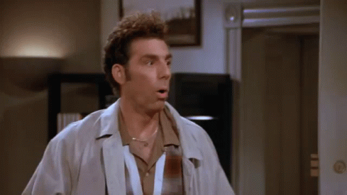 A Man With A Lanyard Around His Neck Is Standing In Front Of A Door GIF
