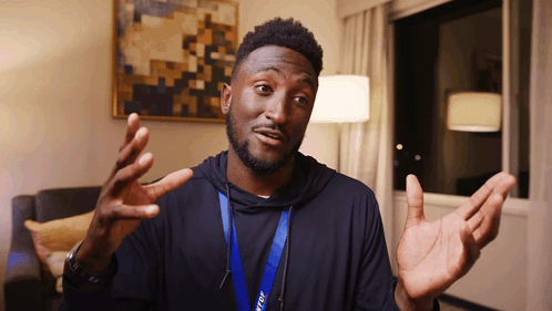 A Man With A Lanyard Around His Neck That Says ' Tcl ' On It GIF