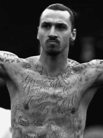 A Man With A Lot Of Tattoos On His Chest Including One That Says ' Gima ' GIF
