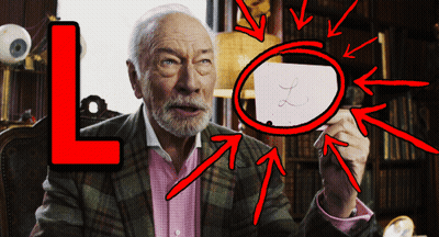 A Man With A Magnifying Glass And A Letter L Behind Him GIF