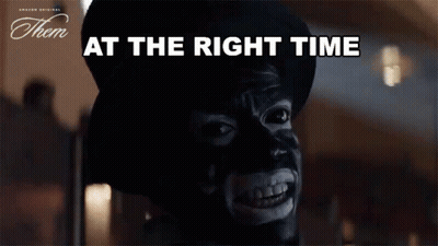 A Man With A Mask On His Face And The Words At The Right Time Below Him GIF