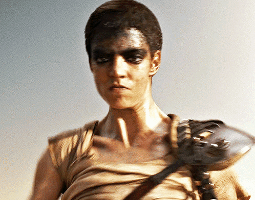 A Man With A Mask On His Face Holds A Gun GIF