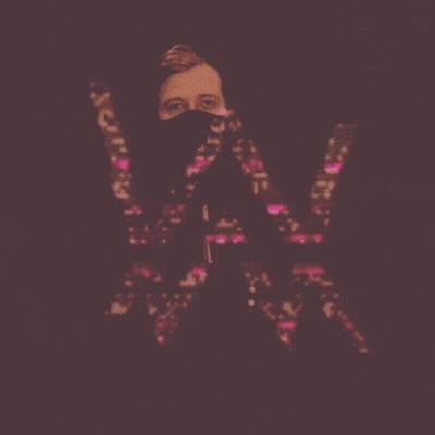 A Man With A Mask On His Face Holds The Letter W GIF