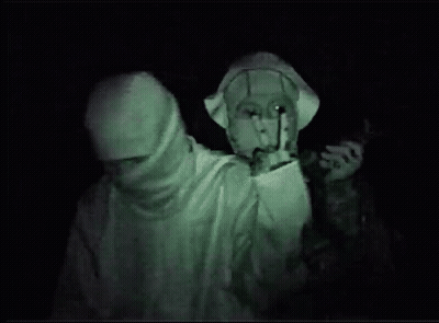 A Man With A Mask On His Face Is Giving The Peace Sign GIF