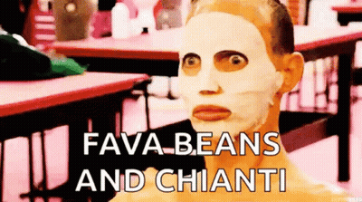 A Man With A Mask On His Face Is Sitting At A Table With The Words Fava Beans And Chianti . GIF