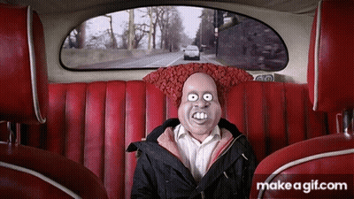 A Man With A Mask On His Face Is Sitting In A Car GIF