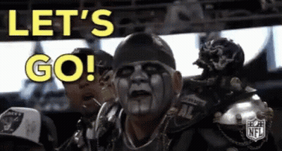 A Man With A Mask On His Face Is Sitting In A Stadium And Says Let 'S Go ! GIF