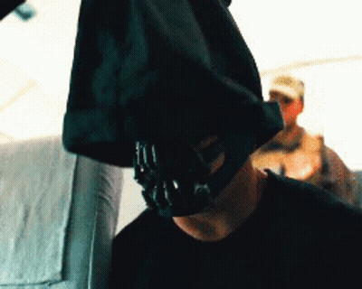 A Man With A Mask On His Face Is Sitting On A Plane GIF
