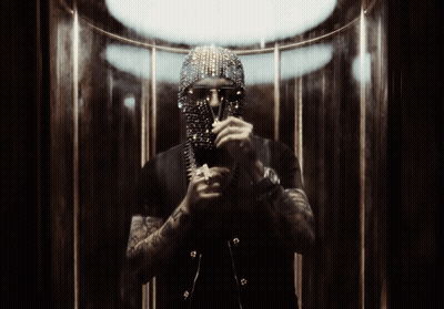 A Man With A Mask On His Face Is Standing In A Dark Room GIF