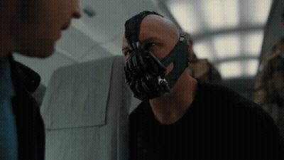 A Man With A Mask On His Face Talking To Another Man GIF