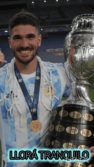 A Man With A Medal Around His Neck Is Holding A Trophy And Says Llora Tranquilo GIF