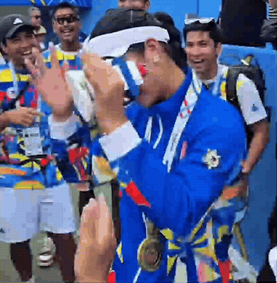 A Man With A Medal Around His Neck Is Wearing Glasses GIF