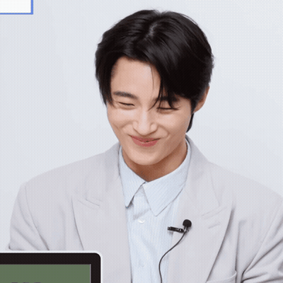 A Man With A Microphone And A Smiley Face On His Face GIF