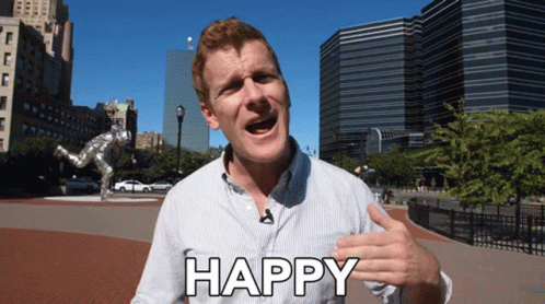 A Man With A Microphone In His Mouth Says Happy GIF