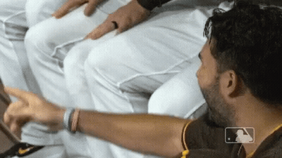 A Man With A Mlb Logo On His Shirt Points To Something GIF