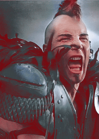 A Man With A Mohawk And Braces On His Teeth GIF