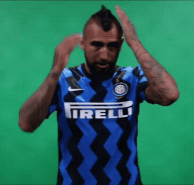 A Man With A Mohawk Is Wearing A Blue And Black Shirt With The Word Irelli On It GIF