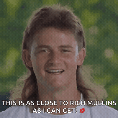 A Man With A Mullet Is Smiling With The Words " This Is As Close To Rich Mullins As I Can Get " GIF