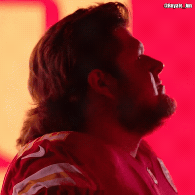 A Man With A Mullet Is Wearing A Red Jersey With The Number 9 On It GIF