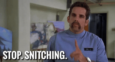 A Man With A Mustache And A Name Tag On His Shirt Is Pointing At Something And Saying Stop Snitching . GIF