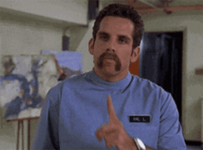 A Man With A Mustache And A Name Tag That Says Mr. L. GIF