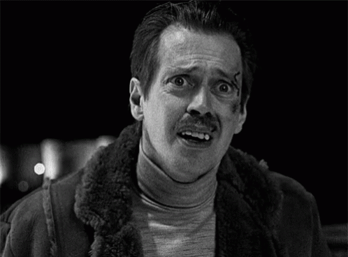 A Man With A Mustache And A Scar On His Face Is Making A Funny Face . GIF