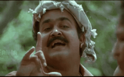 A Man With A Mustache And A Scarf Around His Head Is Making A Funny Face . GIF