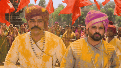 A Man With A Mustache And A Turban Is Covered In Yellow Paint GIF
