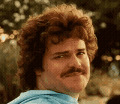 A Man With A Mustache And Curly Hair Is Wearing A Blue Hoodie . GIF