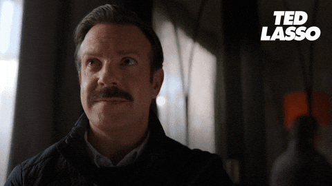 A Man With A Mustache And The Word Ted Lasso On The Bottom GIF