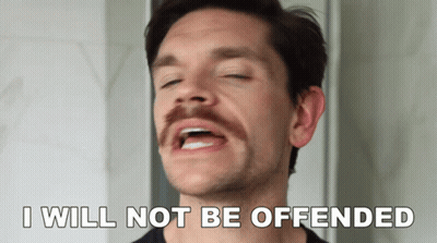 A Man With A Mustache Has His Eyes Closed And Says " I Will Not Be Offended " GIF