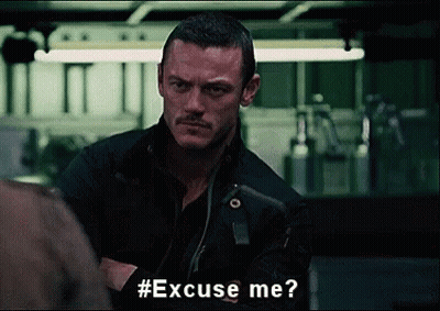 A Man With A Mustache Is Asking Someone To Excuse Him . GIF