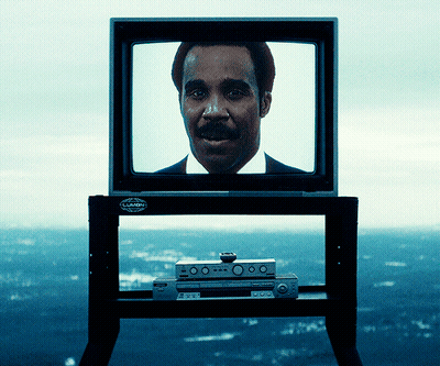 A Man With A Mustache Is Displayed On A Television Which Has A Sticker On It That Says ' Pioneer ' GIF