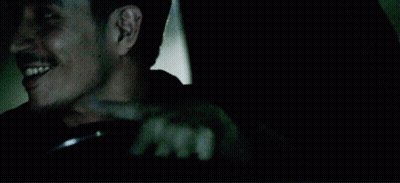 A Man With A Mustache Is Driving A Car And Smiling GIF