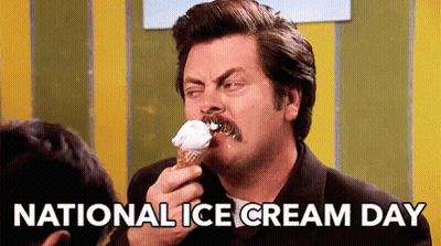 A Man With A Mustache Is Eating A Cone Of Ice Cream On National Ice Cream Day . GIF