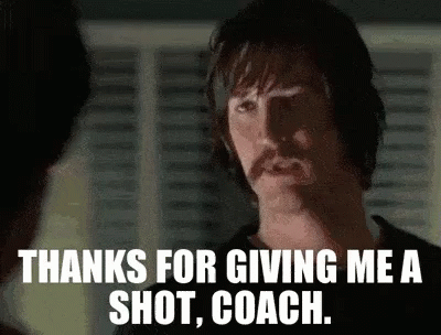 A Man With A Mustache Is Giving A Shot To Another Man . GIF