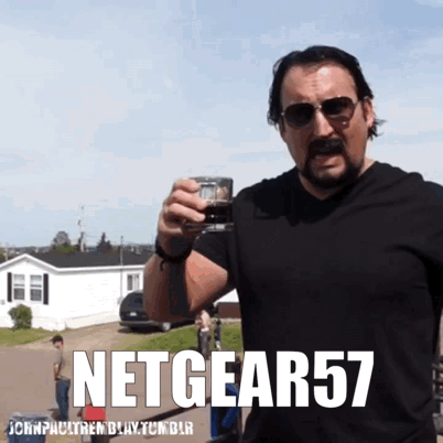 A Man With A Mustache Is Holding A Glass With The Words Netgear57 Written On The Bottom GIF