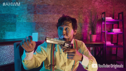 A Man With A Mustache Is Holding A Gun In Front Of A Sign That Says Youtube Originals GIF