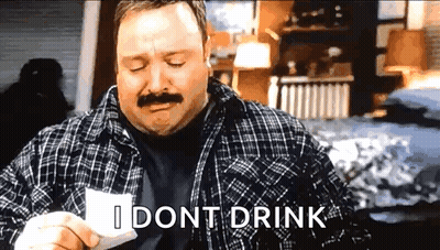 A Man With A Mustache Is Holding A Piece Of Paper And Says I Dont Drink . GIF