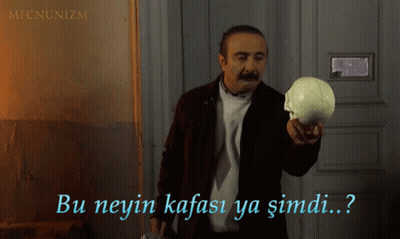 A Man With A Mustache Is Holding A Skull And Says Bu Neyin Kafasi Ya Simdi GIF