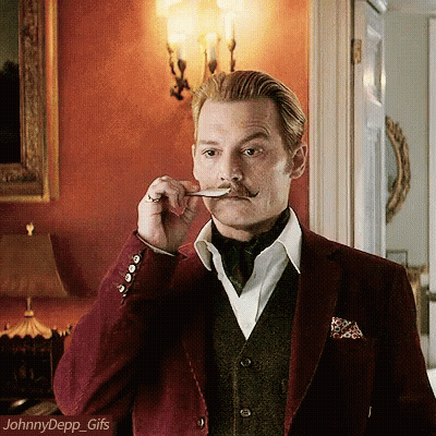 A Man With A Mustache Is Holding A Spoon In His Mouth And The Name Johnny Depp Is On The Bottom GIF