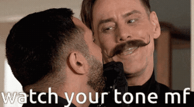 A Man With A Mustache Is Kissing Another Man On The Cheek With The Words " Watch Your Tone Mf " Below Him GIF