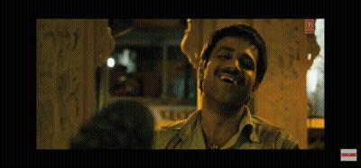 A Man With A Mustache Is Laughing In A Dark Room With Graffiti On The Wall . GIF