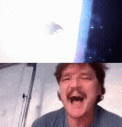 A Man With A Mustache Is Laughing With His Mouth Open In Front Of A Screen . GIF