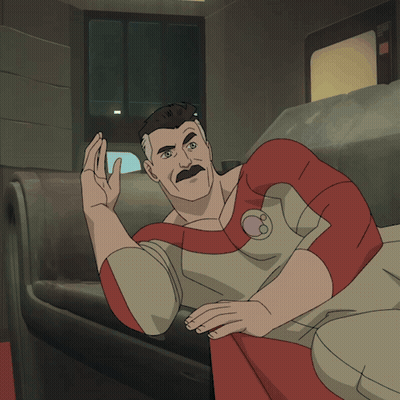 A Man With A Mustache Is Laying On A Couch And Waving GIF